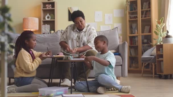 Afrikansk Amerikansk Mormor Och Två Barnbarn Som Träffas Vardagsrummet Fritiden — Stockvideo