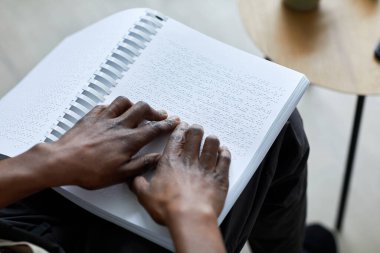 Evde dinlenirken ya da ders çalışırken kitap okuyan tanınamayan kör adamın resmini çek, boşluğu kopyala.