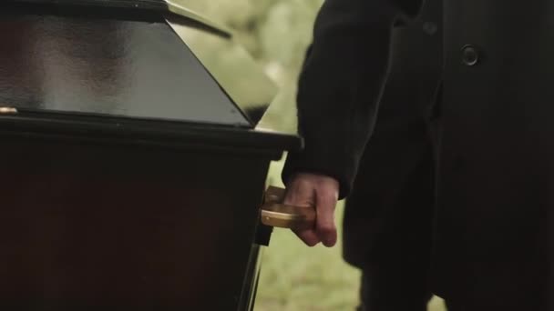 Cropped Shot Unrecognizable Pallbearers Carrying Elegant Black Wooden Coffin Cemetery — Stock Video