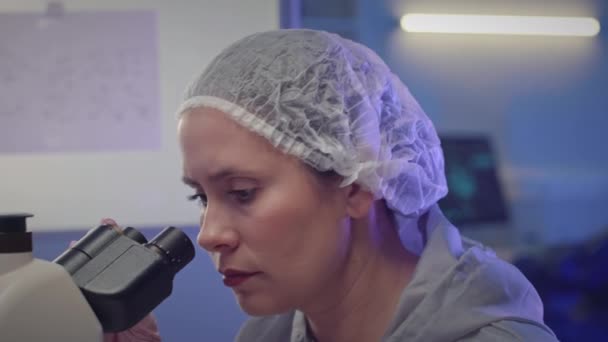 Medium Closeup Young Caucasian Female Scientist Protective Clothing Examining Cultures — Stock Video