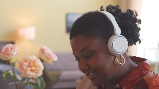 Średnie Zbliżenie Wesołej Młodej Czarnej Kobiety Korzystającej Muzyki Bezprzewodowych Słuchawkach — Wideo stockowe