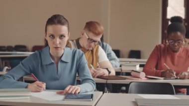 Çok ırklı arkadaşlarla konferans masasında oturup ders yazarken profesöre soru soran Kafkasyalı kadın öğrencilerin belini kaldır.
