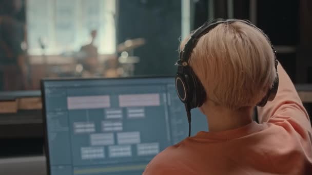 Ses Stüdyosunda Çalışan Kulaklıklı Kadın Prodüktörün Arka Planında Müzik Grubu — Stok video