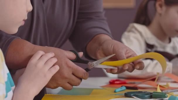 Przycięte Ujęcie Nierozpoznawalnej Nauczycielki Używającej Nożyczek Pomagając Dzieciom Robić Rzemiosło — Wideo stockowe