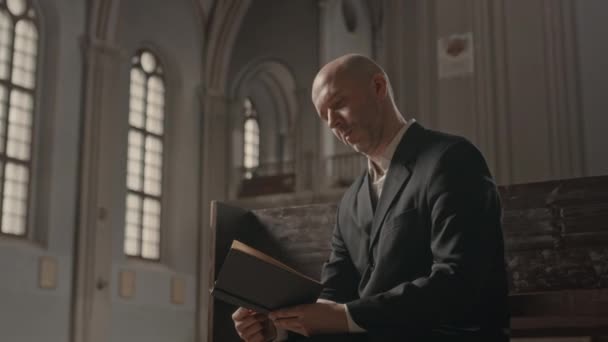 Medium Shot Middle Aged Bald Headed Caucasian Priest Suit Reading — Stock Video