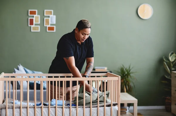 Portrait Tattooed Gay Woman Preparing Baby Crib Minimal Home Interior — Stock Photo, Image