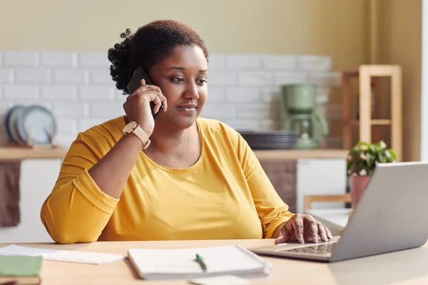 Portrait of black young woman doing business while working from home