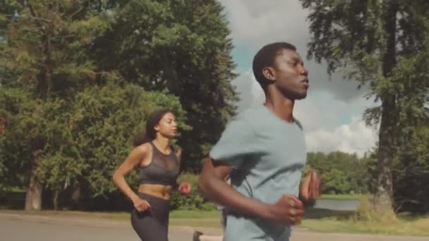 Střední Zpomalení Mladého Atletika Černoch Mnohonásobnými Přáteli Jogging Parku Slunný — Stock video