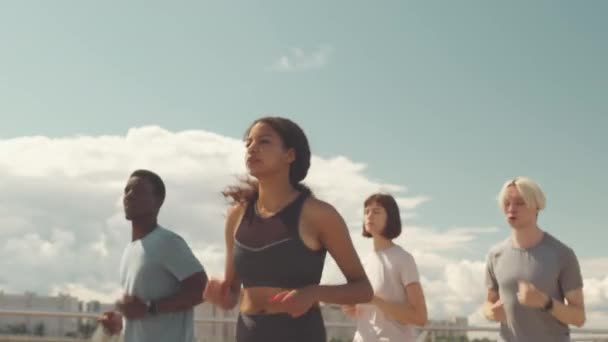 Medium Slowmo Group Young Diverse Athletes Running Bridge Outdoors Hot — Stock Video