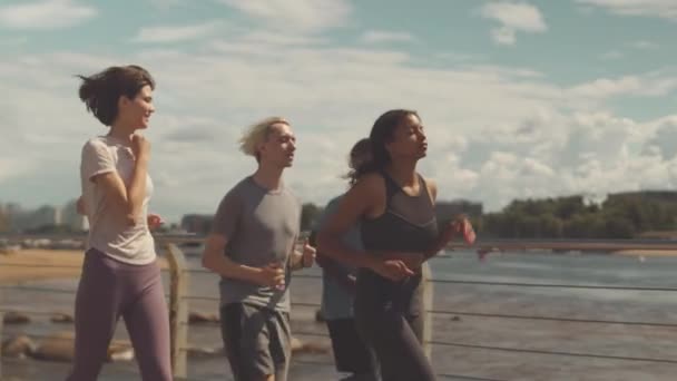 Medium Slowmo Group Young Multiethnic Sportsmen Jogging Outdoors Summer — Stock Video