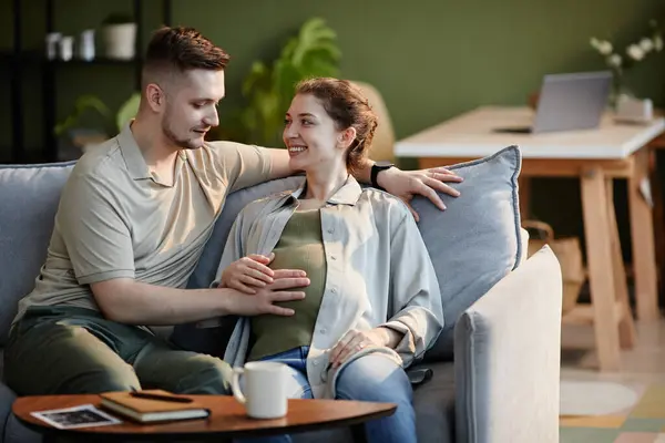 Young Man Stroking Pregnant Belly His Wife While Sitting Sofa — Stock Photo, Image