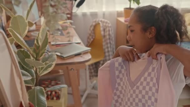 中镜头中 10岁的非洲裔美国女孩在明亮的儿童卧室的镜子前跳舞 试穿五颜六色的新衣服 — 图库视频影像