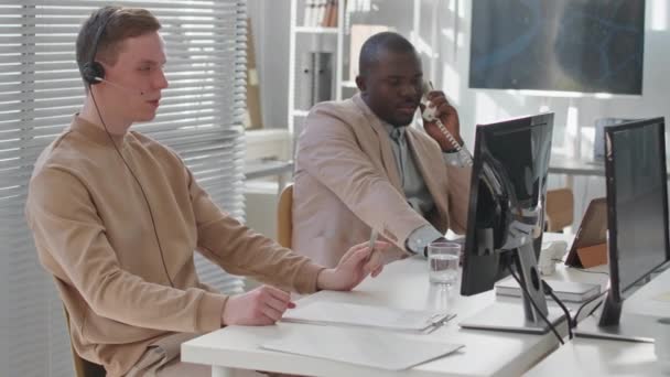Medium Slowmo Two Multiracial Security Service Operators Working Desk Modern — Stock Video