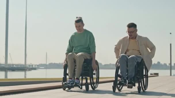 Sledování Záběr Dvou Mladých Šťastných Bělochů Invalidních Vozících Závodní Podél — Stock video