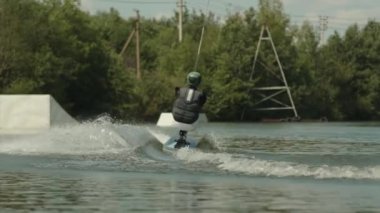 Engelli birinin görüntüsü. Uyarlanabilir bir panelde oturup, nehirde açık havada uyanırken halat tutarken.
