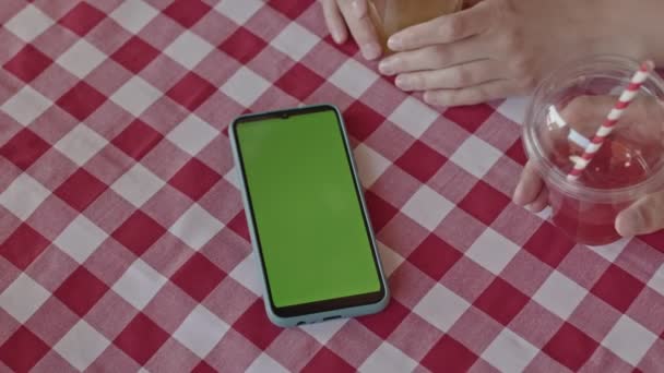 基于绿色彩色键模板屏幕的智能手机在室外咖啡桌上的关闭 — 图库视频影像
