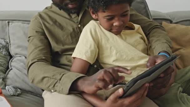 Tilt Black Man Preteen Son Playing Games Tablet Together Cozy — Stock Video
