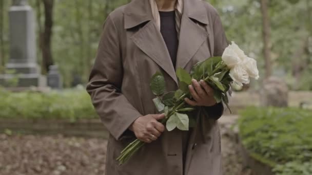 Przycięty Strzał Nierozpoznawalnej Kobiety Bukietem Białych Róż Spacerujących Cmentarzu Dzień — Wideo stockowe