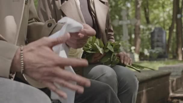 Przycięte Ujęcie Dwójki Ludzi Żałobie Białymi Różami Chusteczkami Rękach Siedzących — Wideo stockowe