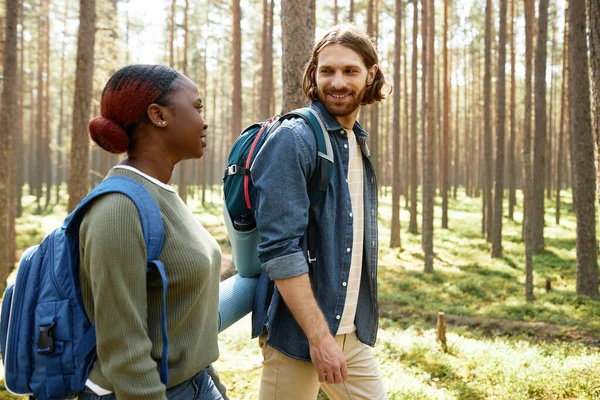 Young Multiethnic Couple Backpacks Walking Talking Together Forest — Stock Photo, Image