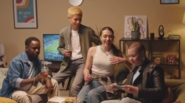 Akşamları birlikte evde meşrubat ve fast food içerek geçirirken, dört farklı hipster arkadaşın akıllı telefondan selfie portresi çekerken orta boy bir fotoğraf.