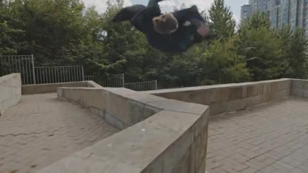 Active Young Guy Doing Somersault While Practicing Parkour Tricks Building — Stock Video