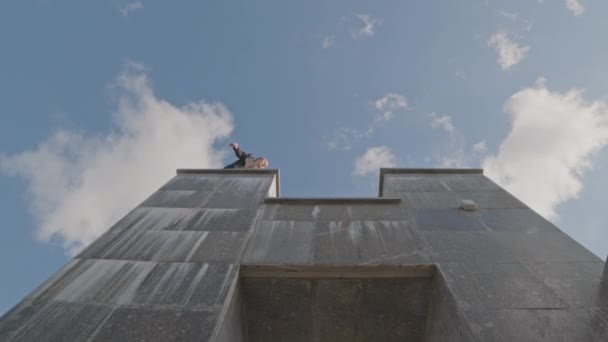 Bajo Ángulo Tiro Parkourist Saltando Columna Columna Bajo Cielo Azul — Vídeo de stock
