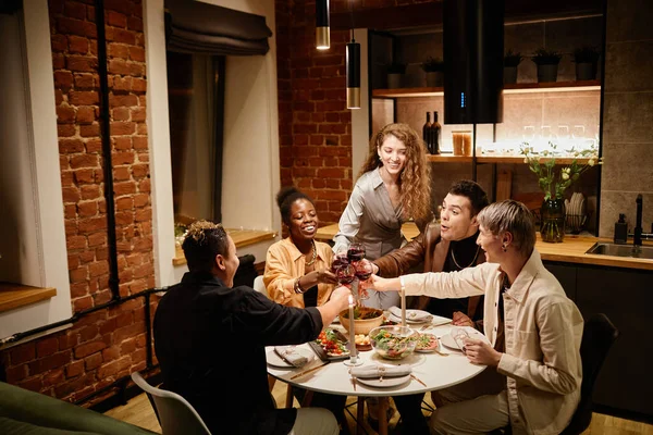 Group Young Intercultural Friends Sitting Served Table Kitchen Clinking Glasses — Stock Photo, Image