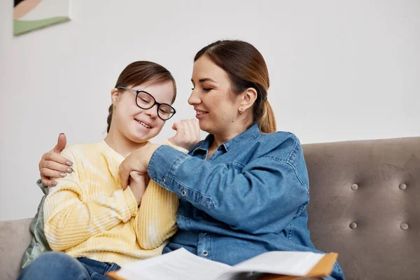 Portrait Happy Teenage Girl Syndrome Cuddling Mother While Sitting Couch — Stock Photo, Image