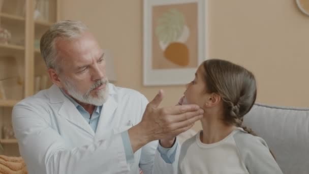Medium Shot Professional Caucasian Male Doctor Touching Neck Asian Little — Stock Video