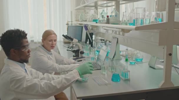 Waist Multiracial Couple Chemists Lab Coats Talking While Making Experiments — Stock Video