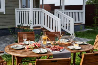 Yaz partisi için hazırlanmış taze meyve ve böğürtlenli ahşap yemek masasının arka plan görüntüsü.