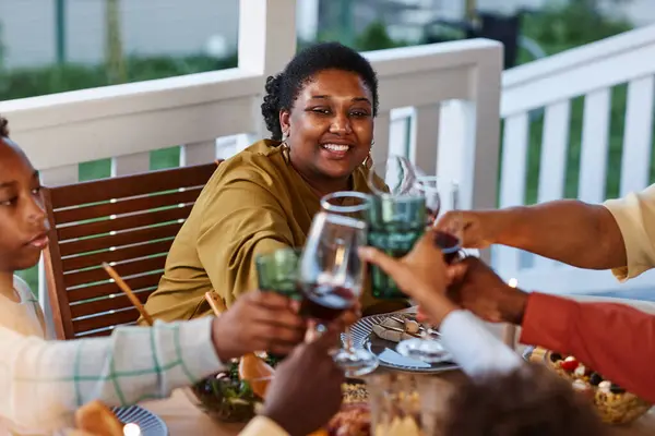 Portrait Smiling Black Woman Clinking Glasses Dinner Table Outdoors Cozy — Stock Photo, Image