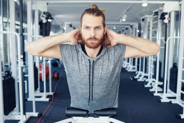 stock image Portrait of young man doing exercises on his back in gym during his rehabilitation