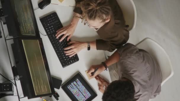 現代オフィスのホワイト デスクに座っている間 コンピュータでプログラミング コードを書くソフトウェアの専門家のトップビュー刺しショット — ストック動画