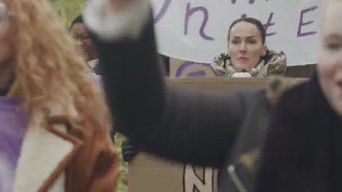 Sokak sürecinde cinsiyet eşitliği için mücadele ederken, feminist sloganlarla bağıran ve posterler sergileyen aktif genç kadınların birlik pozlarını belden yukarı kaldırın