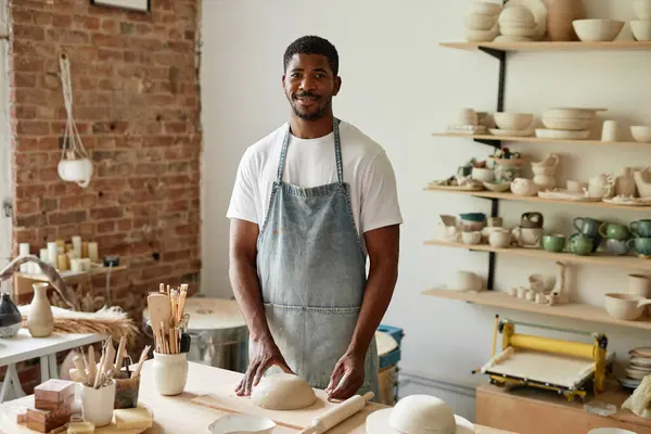 stock image Waist up portrait of smiling African American man wearing apron in pottery studio and looking at camera, copy space