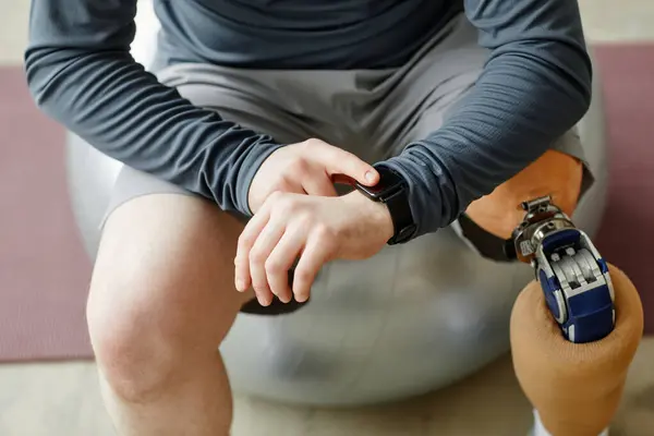 Detailní Záběr Muže Protézou Nohy Kontrolu Smartwatch Sedí Fitness Míč — Stock fotografie