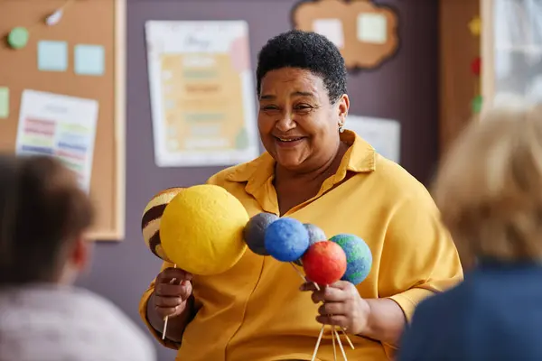 Happy Mature African American Teacher Planet Models Speaking Solar System — Stock Photo, Image