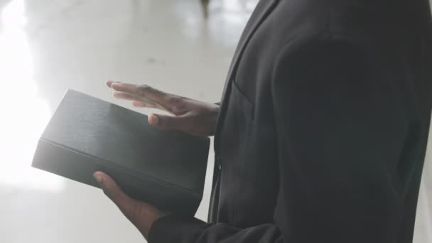 Cropped Shot Unrecognizable Black Male Priest Holding Bible While Standing — Stock Video