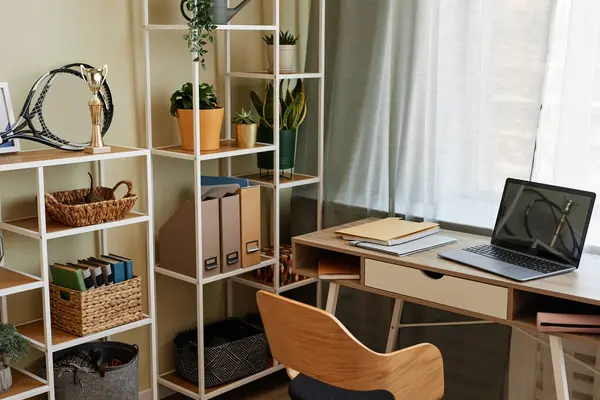 Background image of cozy home office workplace with wooden details and metal shelves with decor items, copy space