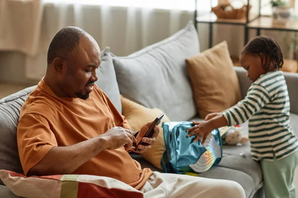 Side View Portrait Father Using Smartphone Sofa Home Son Playing — Stock Photo, Image
