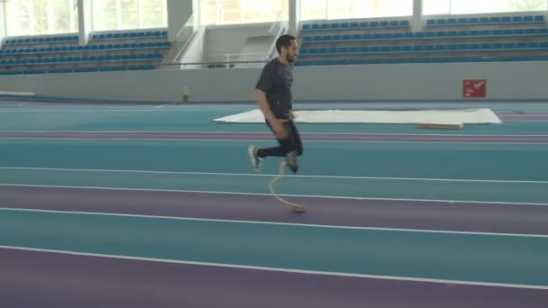 Athletic Young Caucasian Man Disability Running Blade Indoor Stadium — Stock Video