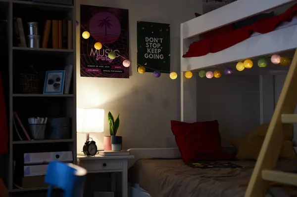 Background image of cozy teen room with bunk bed and string lights garland in dark, copy space