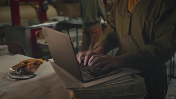 Ujęcie Młodej Białej Kierowniczki Laptopa Umieszczonego Stosie Świeżo Wyprodukowanego Papieru — Wideo stockowe