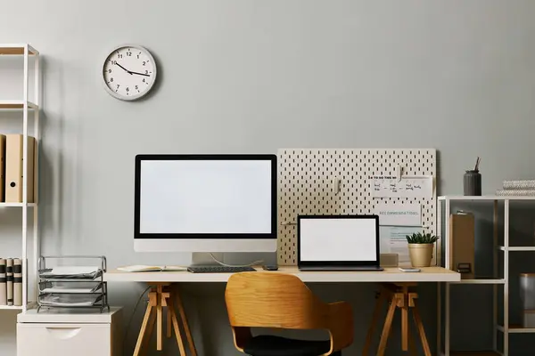 Background image of modern office workplace setup with two screen mockups on desk, copy space