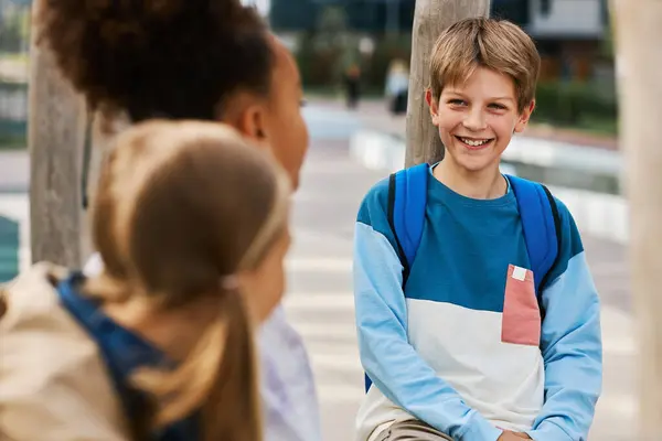 Cute Laughing Schoolboy Blue Pullover Chatting Two Intercultural Classmates Lessons — Stock Photo, Image