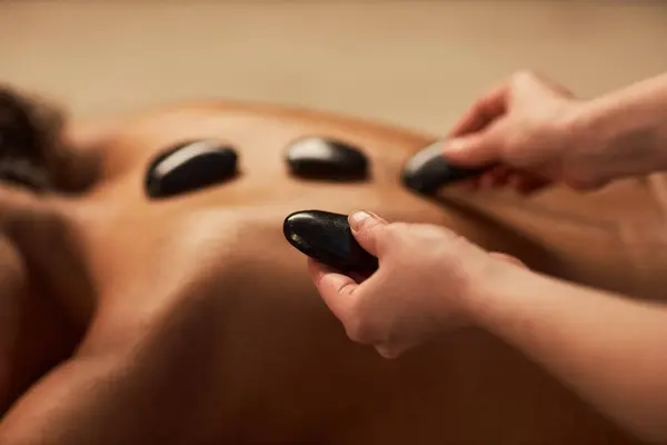Spa Therapist Putting Hot Stones Back Young Woman — Stock Photo, Image