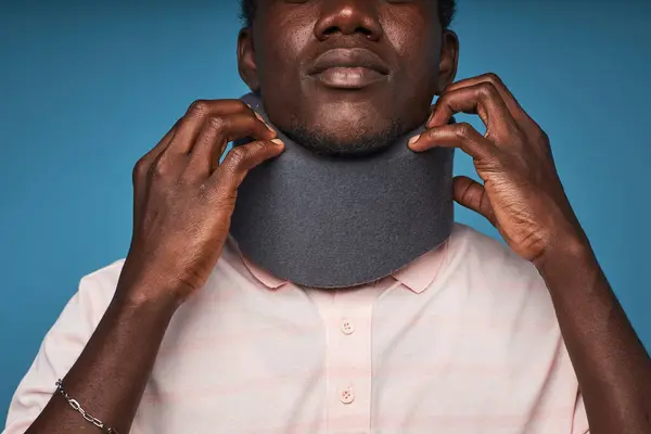 Close Black Man Wearing Neck Brace Trying Take Blue Background — Stock Photo, Image