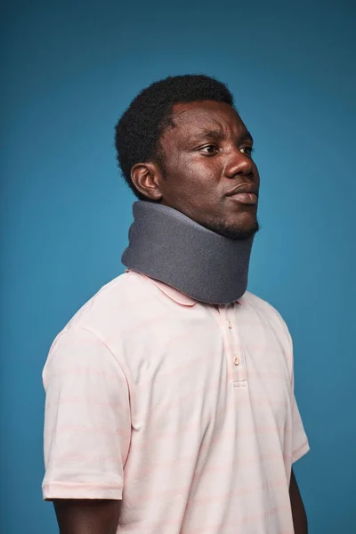 Vertical Portrait Black Man Wearing Neck Brace Vibrant Blue Background — Stock Photo, Image